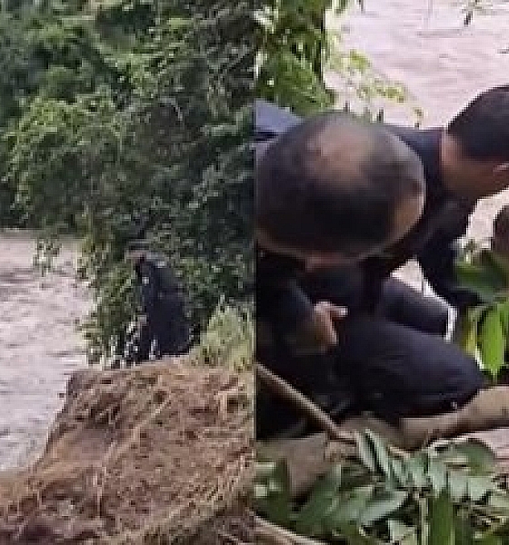 Menino é resgatado por PMs após ficar preso em rio durante tromba d’água